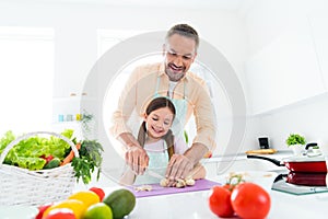 Photo of cheerful sweet father little girl cutting mushrooms preparing breakfast together indoors apartment kitchen