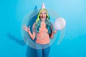 Photo of cheerful young female have birthday party surprised to see all her friends isolated on blue color background