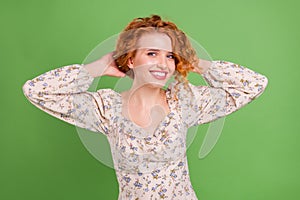 Photo of cheerful young positive lady hold hands hair ginger smile isolated on green color background