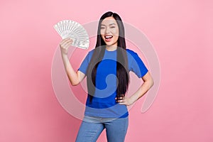 Photo of cheerful young positive woman hold hands money profit waist isolated on pastel pink color background