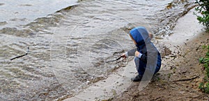 A child playing on a lake shore