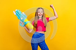 Photo of childish play woman teenager wear pink crop top fist up celebrate victory water guns shooting tournament