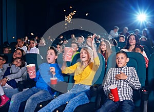 Photo of children sitting on first cinema row.