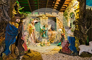 Photo of Christmas Manger scene with figurines including Jesus, Mary, Joseph, sheep and magi