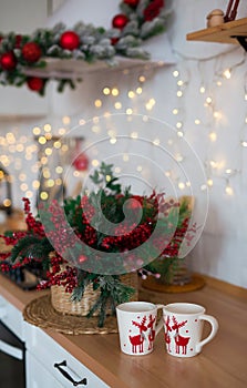 Photo of Christmas table decoration, festive dinnerware with lights and for tea in decorated dinner room, luxury utensil