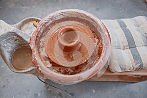 Photo of clay product on pottery wheel in workroom