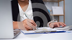 Photo close up hands of business woman working on desk office with using a calculator to calculate the numbers, Finance accounting