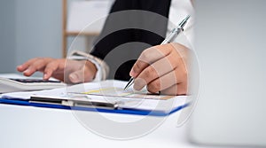 Photo close up hands of business woman working on desk office with using a calculator to calculate the numbers, Finance accounting