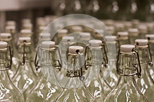 Photo close up many empty glass transparent swing top bottle