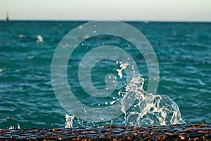Photo closeup of beautiful clear turquoise sea ocean water surface with ripples and bright splash on seascape background