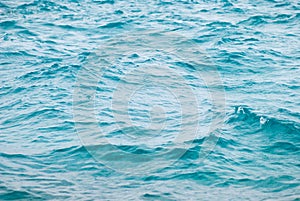 Photo closeup of beautiful clear turquoise sea ocean water surface with ripples low waves on seascape background
