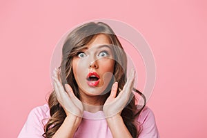 Photo closeup of scared woman with long curly hair in basic t-shirt bulging eyes and raising hands in fear or panic, isolated