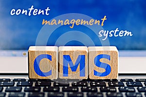 Photo on CMS content management system theme. wooden cubes with the abbreviation