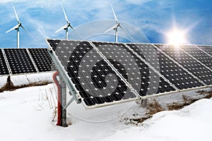 Photo collage of solar panels and wind turbins in winter with snow