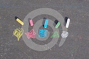 Symbols on asphalt painted by a child with crayons