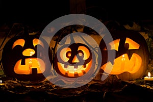 Photo composition from three pumpkins on Halloween.