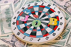 Photo concept. Getting a Job. Image of darts and money