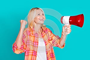 Photo of confident person with blond hair dressed checkered shirt scream in megaphone look empty space isolated on teal