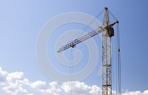 Photo of construction crane against a blue sky background