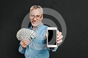 Photo of content retired man 60s with gray hair holding fan of m