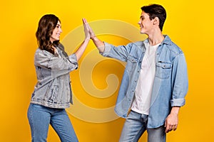 Photo of cool friendly best buddies dressed denim clapping high five isolated yellow color background