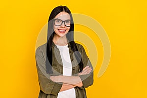 Photo of cool milennial lady crossed arms wear eyewear outfit isolated on yellow color background