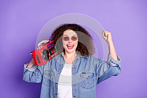 Photo of cool nice girl hold boombox raise fist wear denim shirt isolated on violet color background