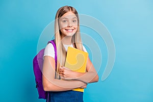 Photo of cool nice teen girl go to school take book bag wear denim dress  on pastel blue color background
