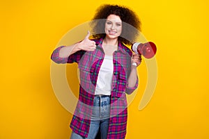 Photo of cool pretty woman dressed plaid shirt making announcement bullhorn isolated yellow color background