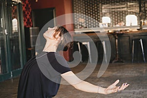 Photo with copy space of a female new yoga teacher in a backbend pose with open arms in her vinyasa flow yoga practice