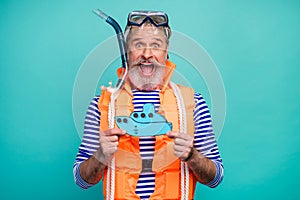 Photo of crazy aged seaman bottom underwater breathing tube mask excited diver hold paper ship wear striped sailor shirt