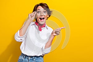 Photo of crazy amazed girl funny person pointing finger empty space unexpected glamour boutique offer isolated on yellow