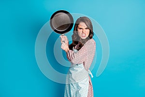 Photo of crazy angry mad outraged lady hold hands kitchen utensil frying pan cooking dinner fight boyfriend beating him