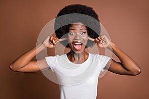 Photo of crazy annoyed lady open mouth fingers close ears wear white t-shirt isolated brown color background