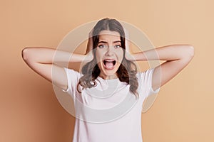 Photo of crazy dissatisfied woman palms covering ears yell loud frustrated look camera