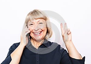 Photo of crazy ecstatic old woman use smartphone impressed social media like feedback win raise fists scream yes