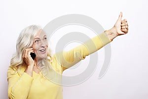 Photo of crazy ecstatic old woman use smartphone impressed social media like feedback win raise fists scream yes