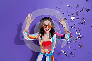 Photo of crazy excited retro lady enjoying occasion in discotheque with flying confetti isolated purple color background