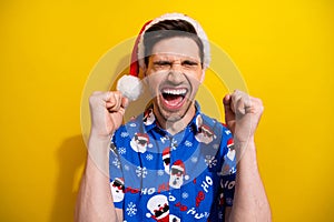 Photo of crazy man raised fists up open mouth yelling wishes dreams comes true hooray holly jolly xmas isolated on