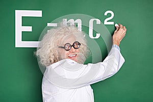 Photo of crazy old man write board chalk formula physics professor lesson isolated on green color background