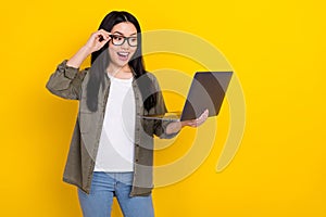 Photo of crazy overjoyed business lady online shopping see huge bargains isolated on yellow color background