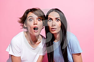 Photo of crazy speechless woman funny reaction open mouth stupor looking you two girls unbelievable isolated on pink