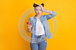 Photo of crazy teen lady two buns hold telephone speechless read comments blog open mouth notification bad news hand