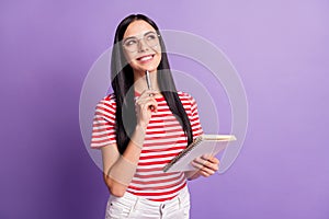 Photo of creative brown haired young woman wear red striped t-shirt hold copybook think article  on violet color