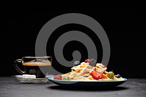 Photo of cup of coffee with Belgian wafers with strawberries, raspberries