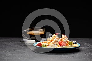 Photo of cup of coffee with Belgian wafers with strawberries, raspberries