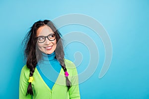 Photo of curious funky happy young woman look empty space dream creative plan isolated on blue color background