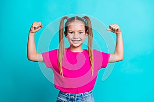 Photo of cute adorable active strong girl wear stylish clothes showing her power biceps triceps muscles isolated on cyan