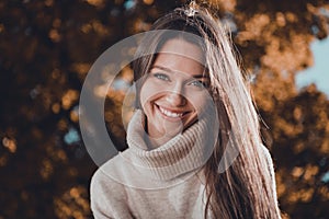 Photo of cute adorable young lady dressed beige collar sweater enjoying fall sunny weather outdoors urban town city park