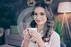 Photo of cute adorable young woman dressed striped shirt glasses having coffebreak inside indoors home room